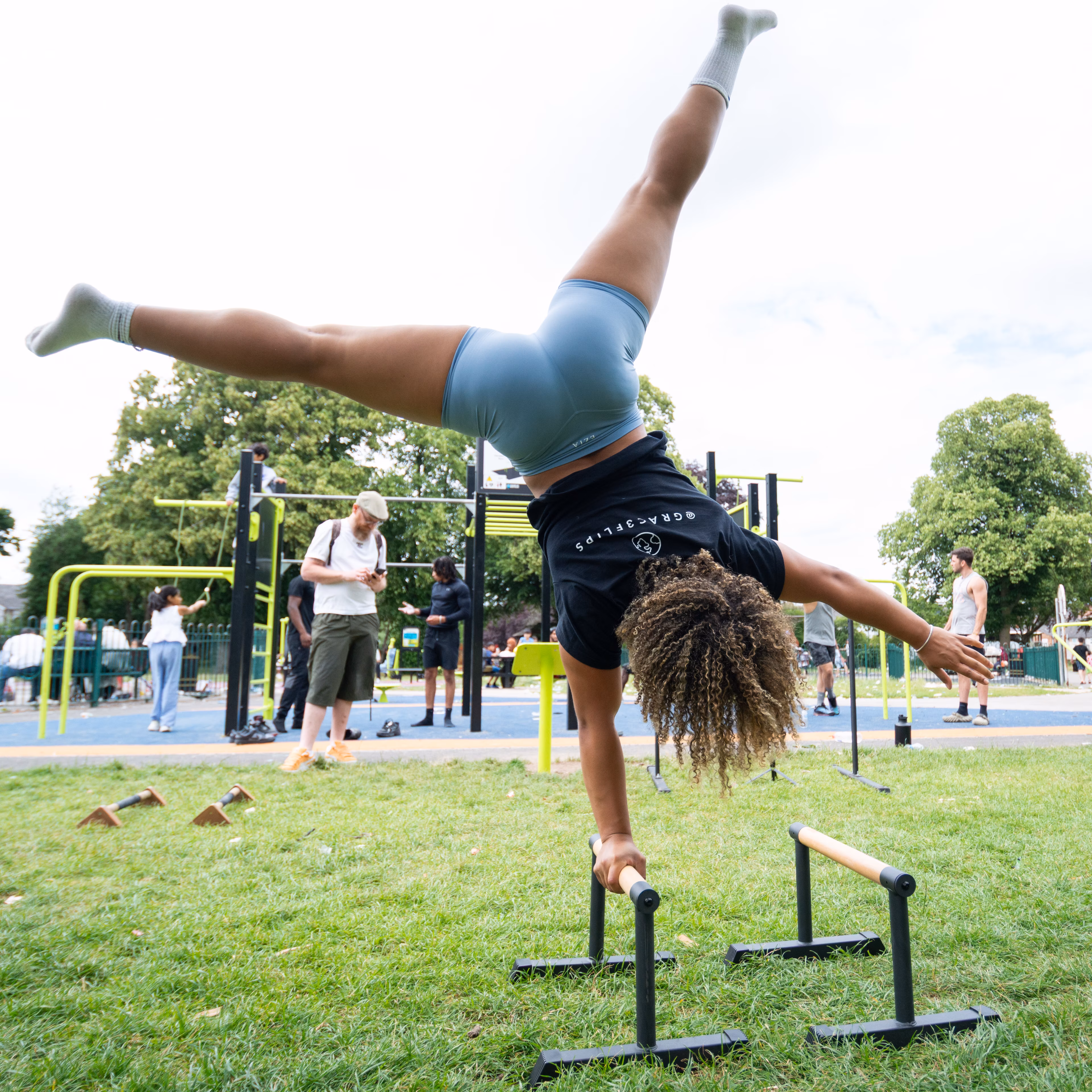 One-arm straddle handstand